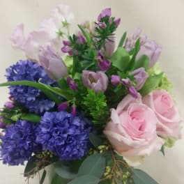Bouquet of pink roses, purple hyacinths, and lavender tulips