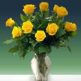 Yellow roses arranged in a clear glass vase