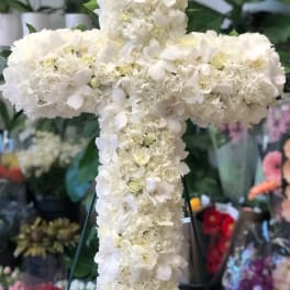 White floral cross on a stand