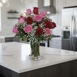 Bouquet of pink and red roses in a clear glass vase