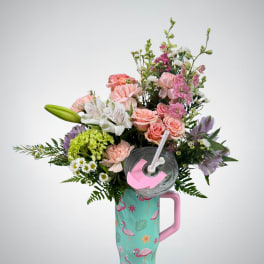 Pink and white mixed flower arrangement in a flamingo tumbler with lid and straw