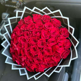 Large bouquet of red roses wrapped in geometric black and white paper