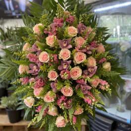 Large standing spray of pink roses and purple orchids