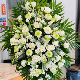 Large white floral standing spray with roses and chrysanthemums