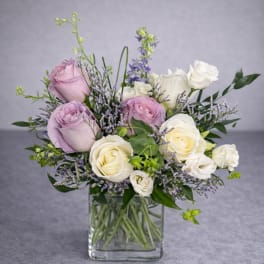 Bouquet of lavender and white roses in a clear glass vase