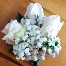 Small white bouquet with pale pink wrapping and baby's breath