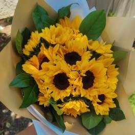 Bouquet of yellow sunflowers wrapped in tan paper