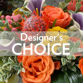 Orange roses with purple calla lilies and yellow filler flowers