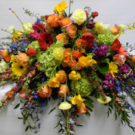 Large colorful floral spray with roses, gerbera daisies, and hydrangeas