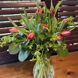Pink tulips arranged in a clear glass vase