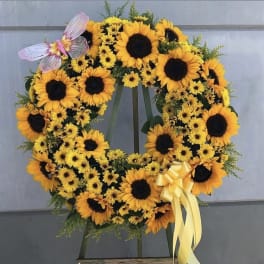 Sunflower wreath with a yellow ribbon and butterfly accent