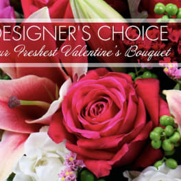 Close-up bouquet of red and white roses with lilies and pink accents
