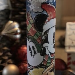 Mickey Mouse holiday candle in a cylindrical holder