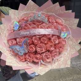 Pink rose bouquet with a tiara and butterfly decorations