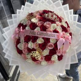 Large bouquet of red, pink, and white roses with a birthday ribbon