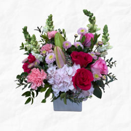 Pink and white floral arrangement in a gray vase