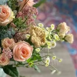 Bouquet of pale pink roses and cream flowers with small filler blooms