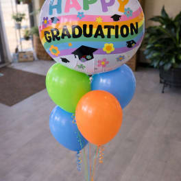 Graduation balloon bouquet with colorful latex balloons and a round "Happy Graduation" balloon