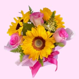 Bouquet of yellow sunflowers and pink roses with a pink ribbon