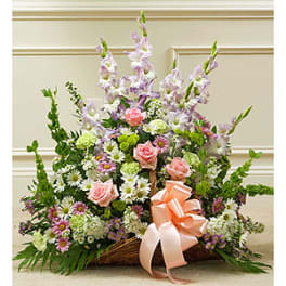 Large basket arrangement with pink roses, daisies, and tall lavender flowers