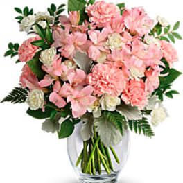 Pink and white bouquet in a clear glass vase