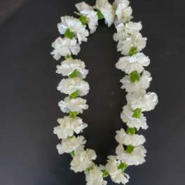 White flower lei on a dark background