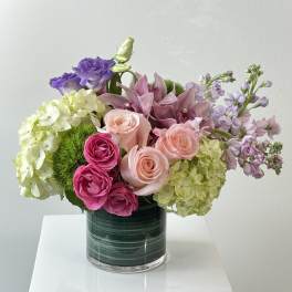 Mixed pink and purple bouquet in a glass vase
