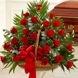 Basket arrangement of red roses with a red ribbon