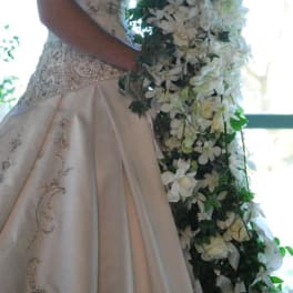 Bride holding a cascading white floral bouquet