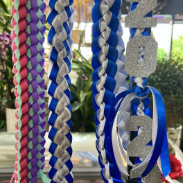 Braided blue, silver, and pink ribbons with glittery 2024 numbers