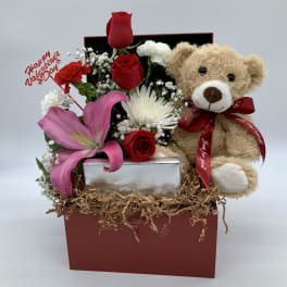 Gift box with red roses, pink lily, and teddy bear