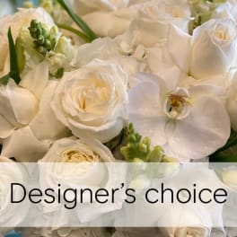 White roses and orchids in a close-up floral arrangement