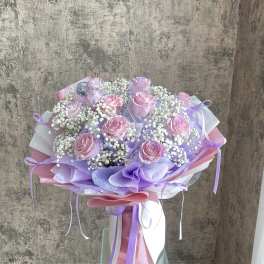 Bouquet of pink roses with white baby's breath and lavender wrapping