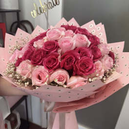 Bouquet of pink and hot pink roses wrapped in pink paper
