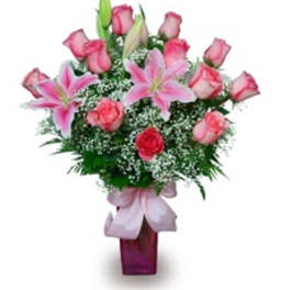 Pink roses and lilies arranged in a purple vase