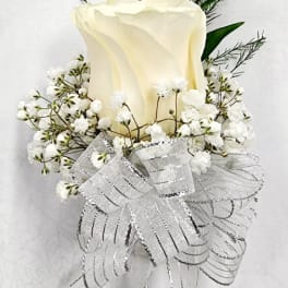 White rose boutonniere with baby's breath and silver ribbon