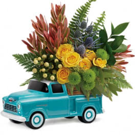 Yellow roses arranged in a turquoise toy truck