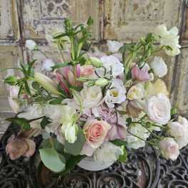 Soft pink and white mixed bouquet in a white vase