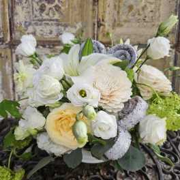 White and cream bouquet with lilies and roses in a vase