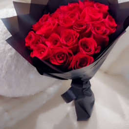 Bouquet of red roses wrapped in black paper