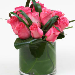 Pink roses arranged in a clear glass vase