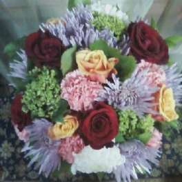 Mixed bouquet of red and yellow roses with pink carnations and purple mums