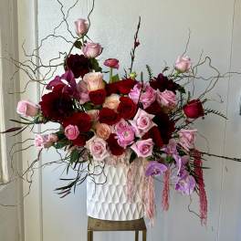 Large bouquet of pink and red roses in a white vase