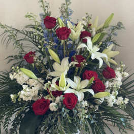Red roses and white lilies in a large vase arrangement