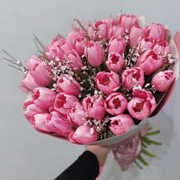 Bouquet of pink tulips with small white filler flowers