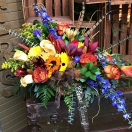 Colorful mixed flower arrangement with roses, lilies, and orchids