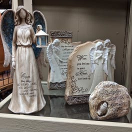 Decorative angel figurines and memorial stones with religious text