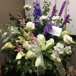Large mixed bouquet with white lilies, roses, and purple flowers