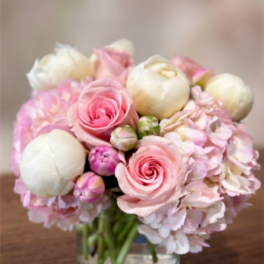 Pink and white bouquet in a clear glass vase