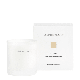 White scented candle with matching box labeled Archipelago Luna